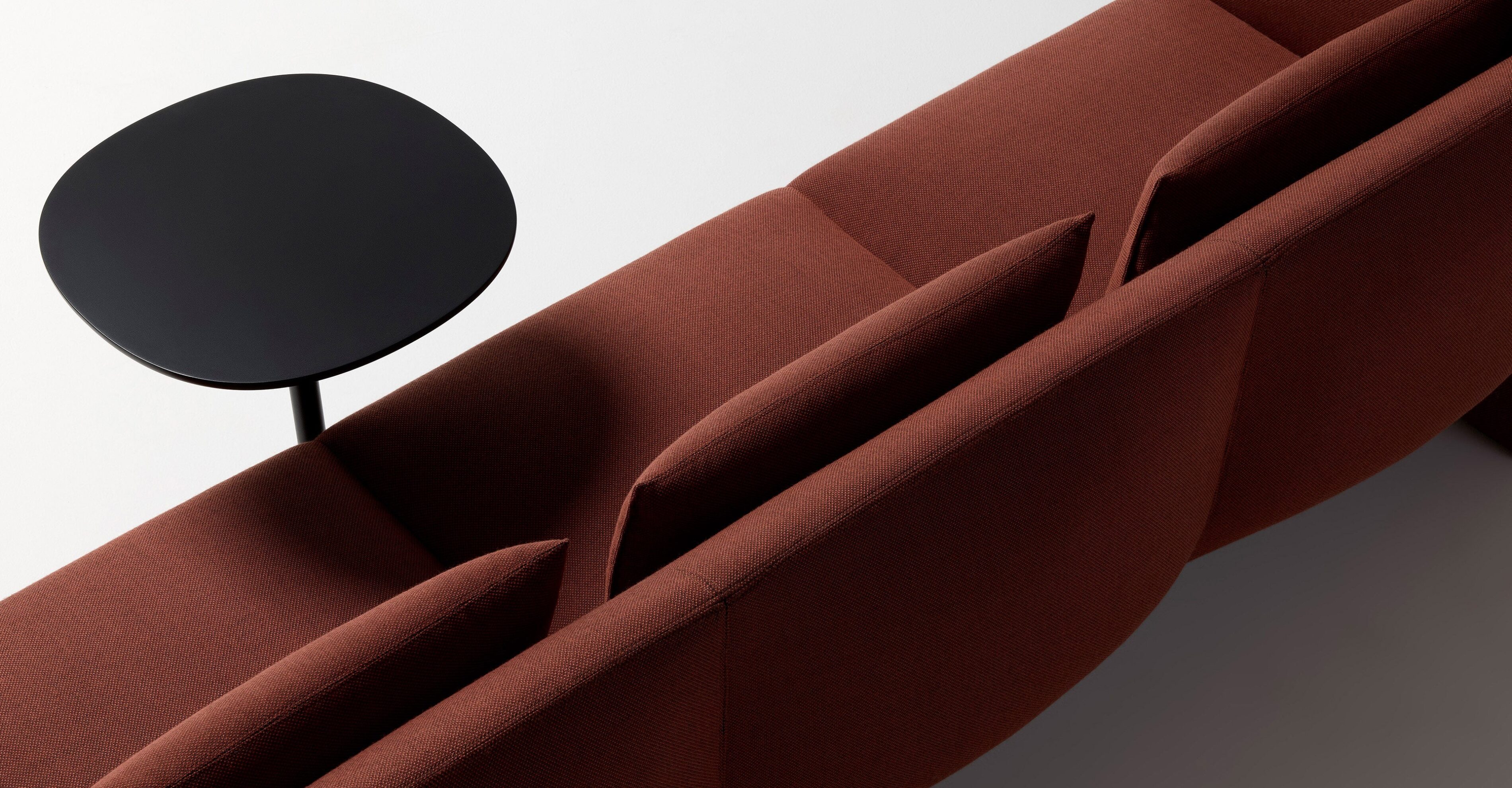 Ross Gardam Dwell lounge in red upholstery from back three quarter view